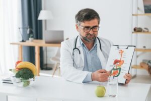 A gastroenterologist is demonstrating the importance of how probiotics and prebiotics impact your digestive system.