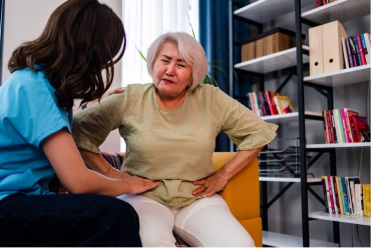 Woman having a medical exam with her doctor and consulting about her abdominal pain causes